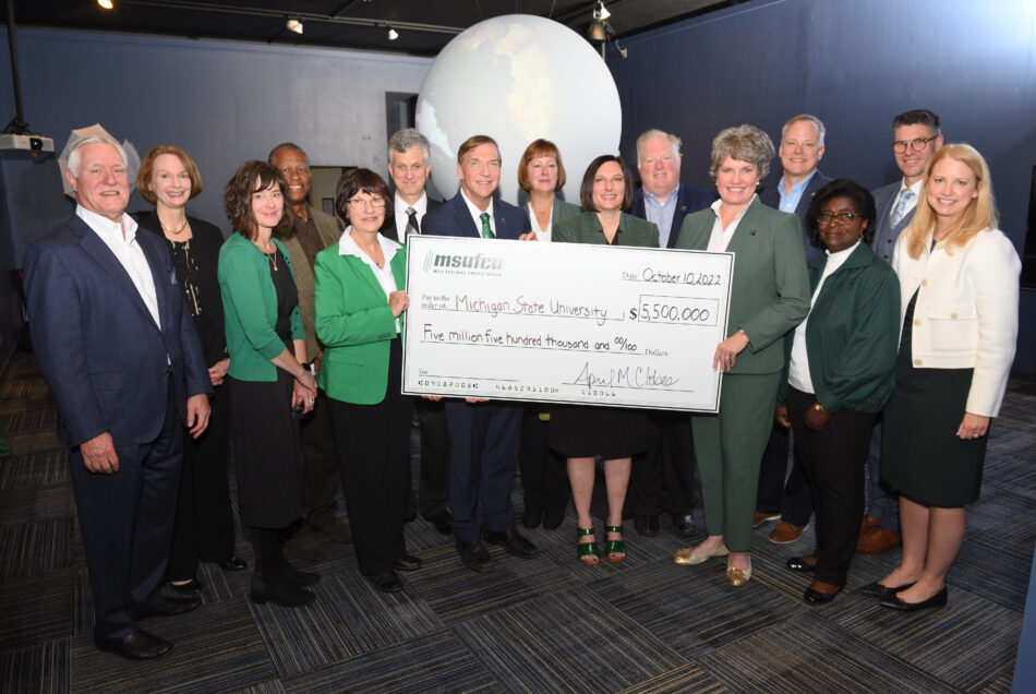 The MSUFCU CEO and board members, along with MSU leaders, holding a large check showcasing a $5 million investment in the arts at MSU.