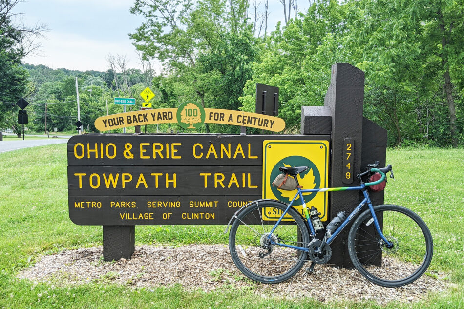 Photo of my bike propped up against the sign for the Ohio to Erie Canal Towpath Trail