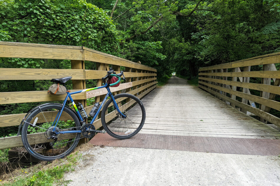 Photo of my bike propped up a small wooden bridge