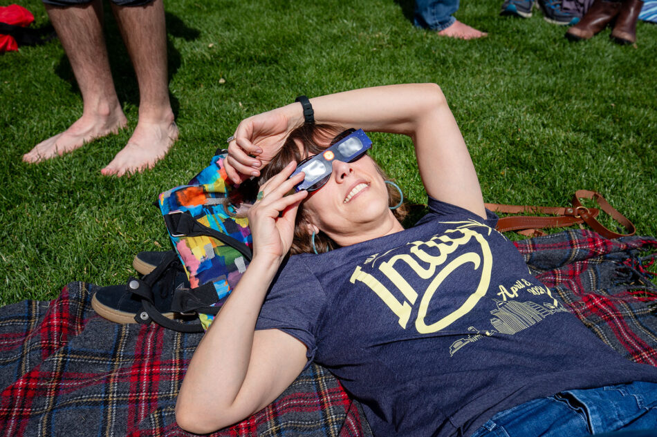 Dharma lying on the grass and enjoying the 2024 total solar eclipse from White River State Park in downtown Indianapolis.