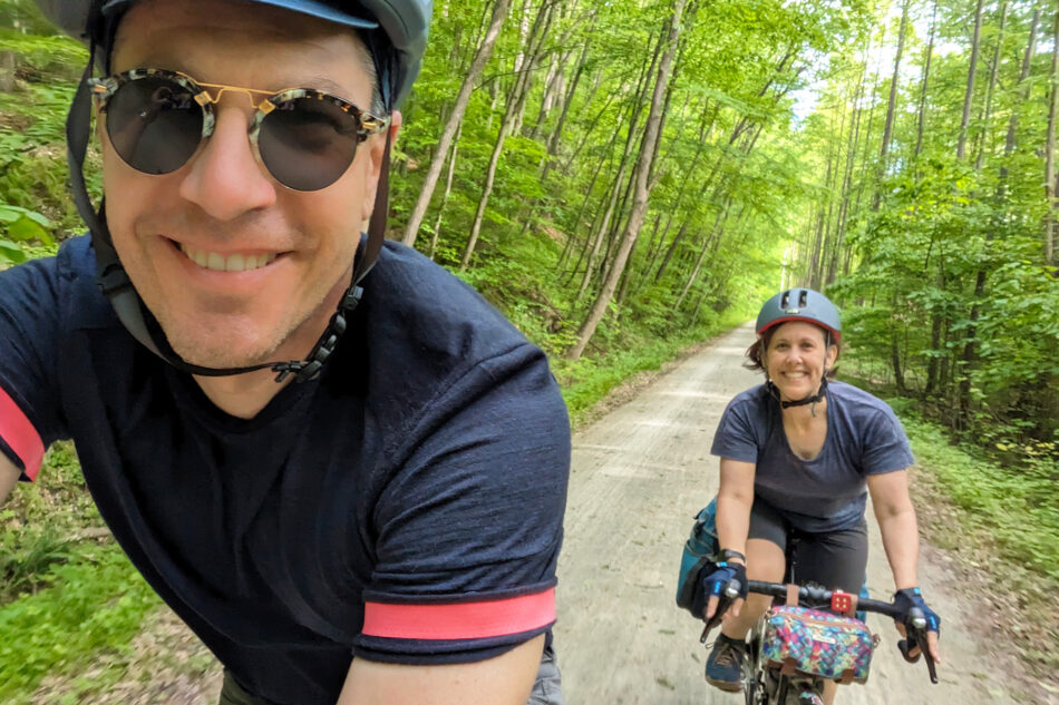 A selfie of Devon and Dharma riding their bikes along the Great Allegheny Passage.