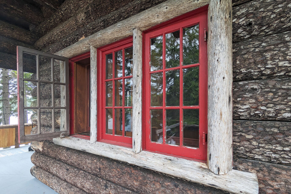 A detailed view of three windows on the front porch of the Main Lodge at Great Camp Sagamore.